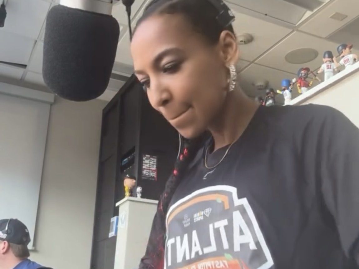 Chelsea in an Atlanta Smoke shirt at the PA mic in the press box